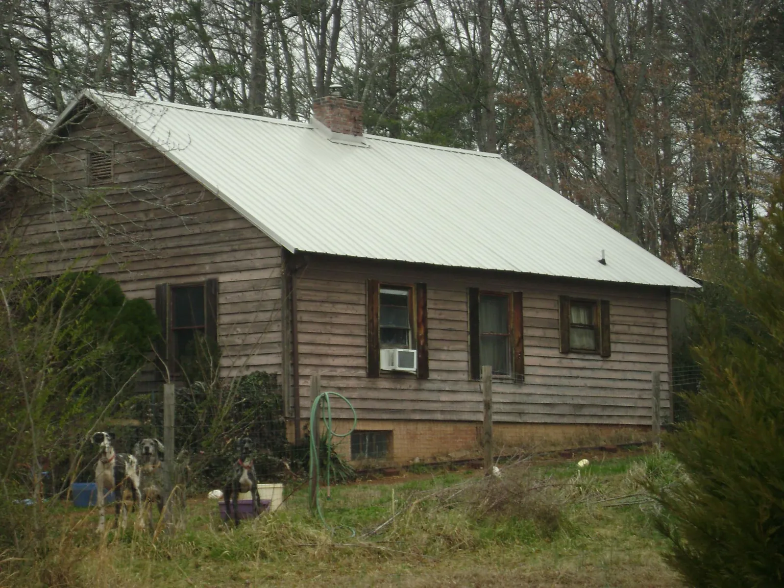 White metal roof on an old wood sided farmhouse, from a Metal Roof Installation job in Blount